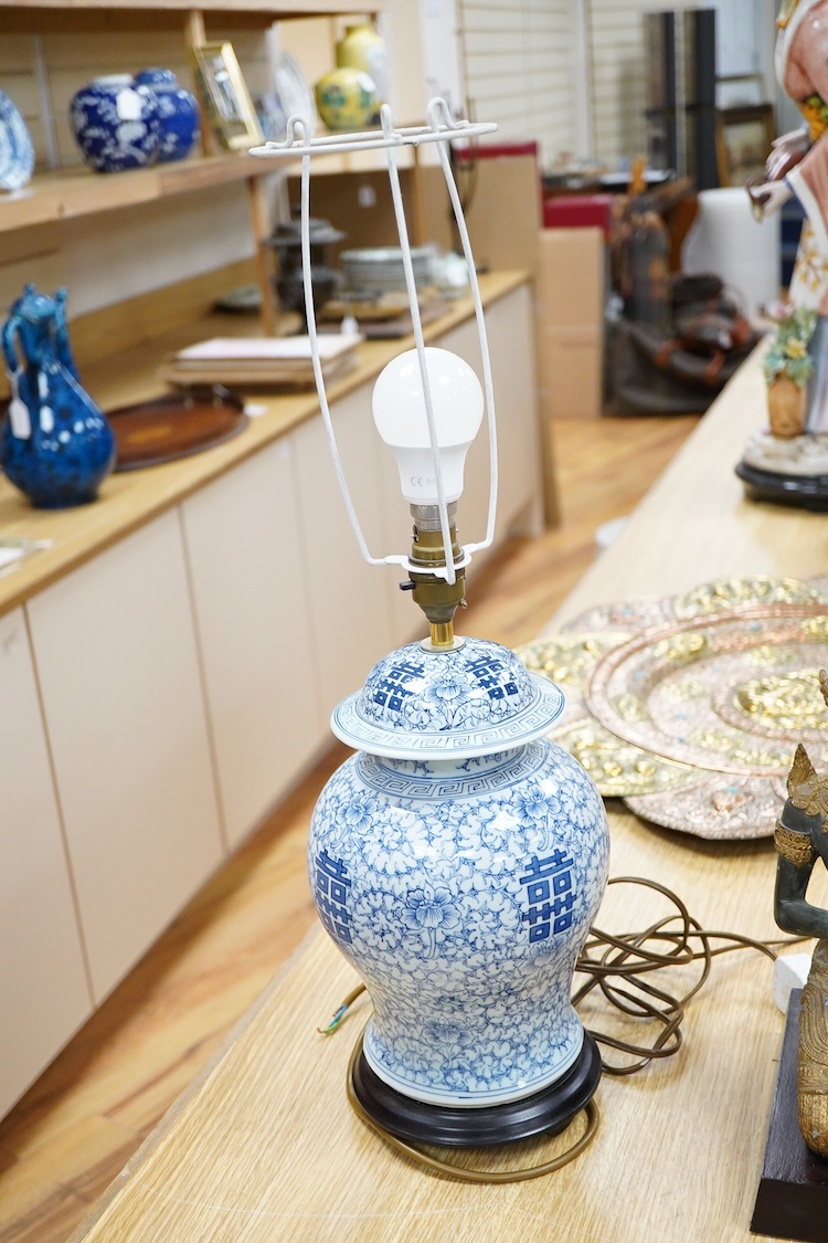 A Chinese blue and white ‘shuangxi’ vase and cover, mounted as a lamp, together with a lamp mounted with a bronze Thai figure, largest 50cm high including light fitting
